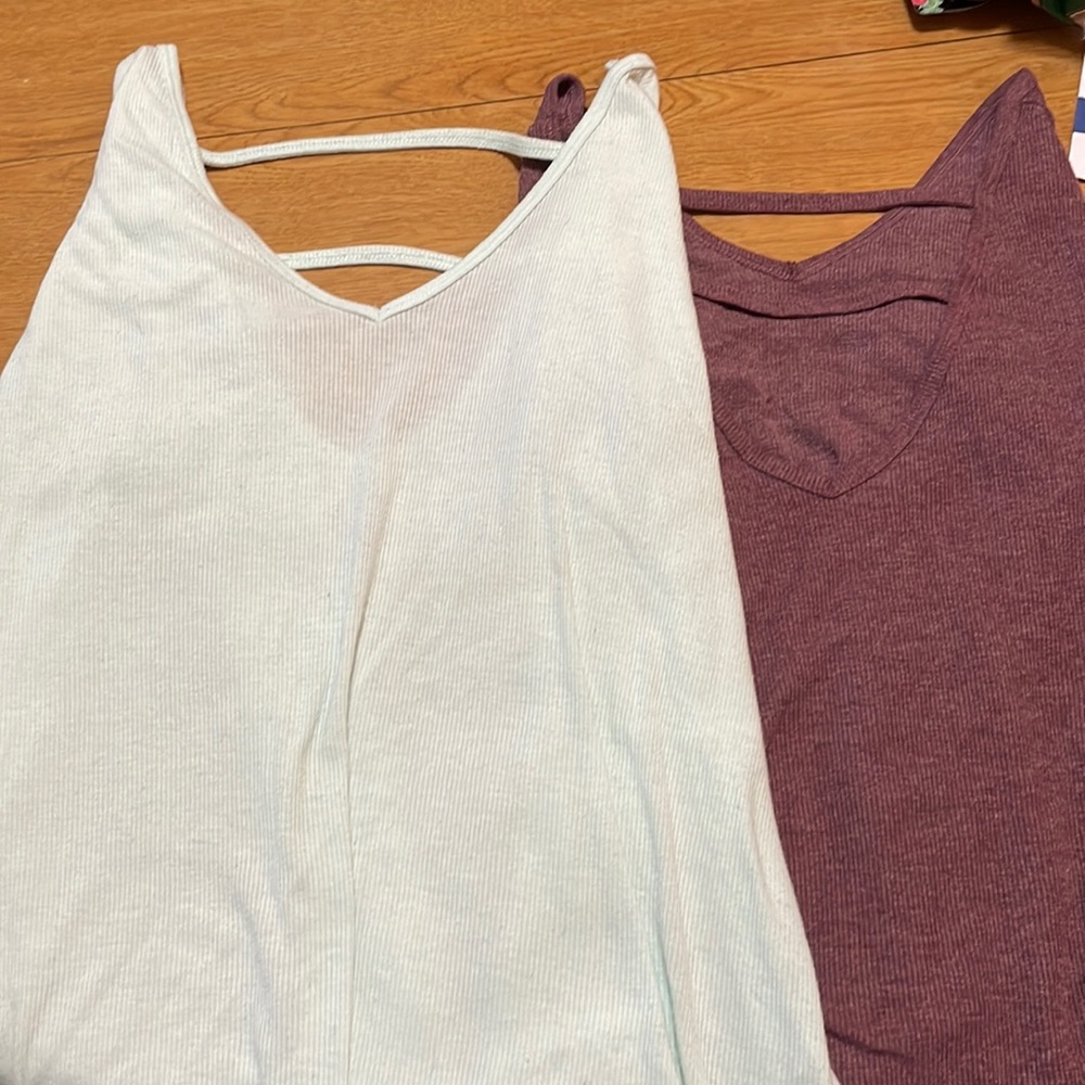 Two long sleeved shirts with straps across back